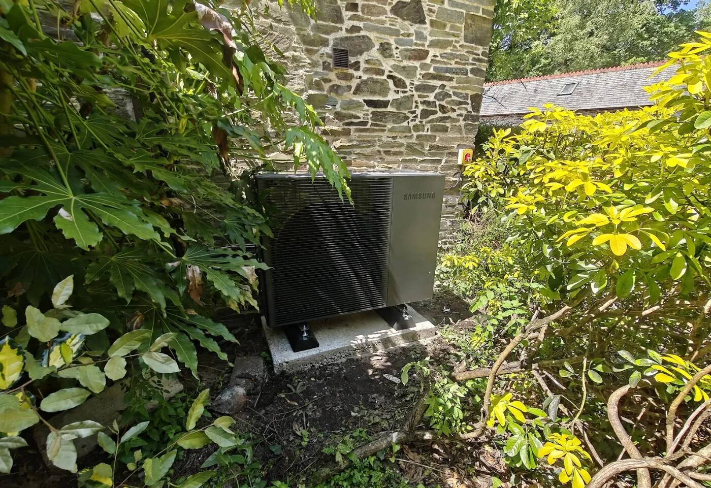 Samsung air source heat pump installed in a garden setting