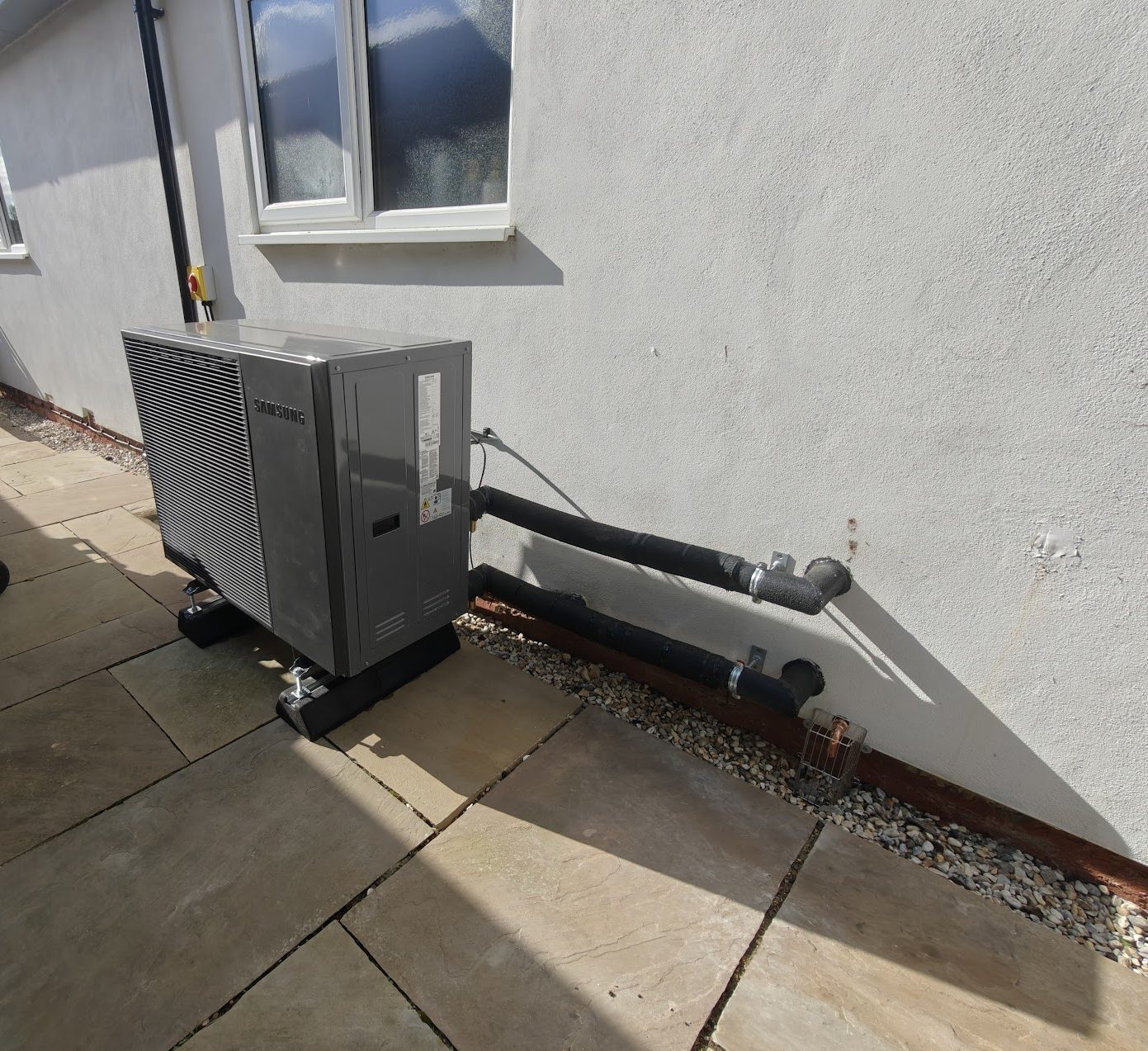 Samsung air source heat pump installation with insulated pipework