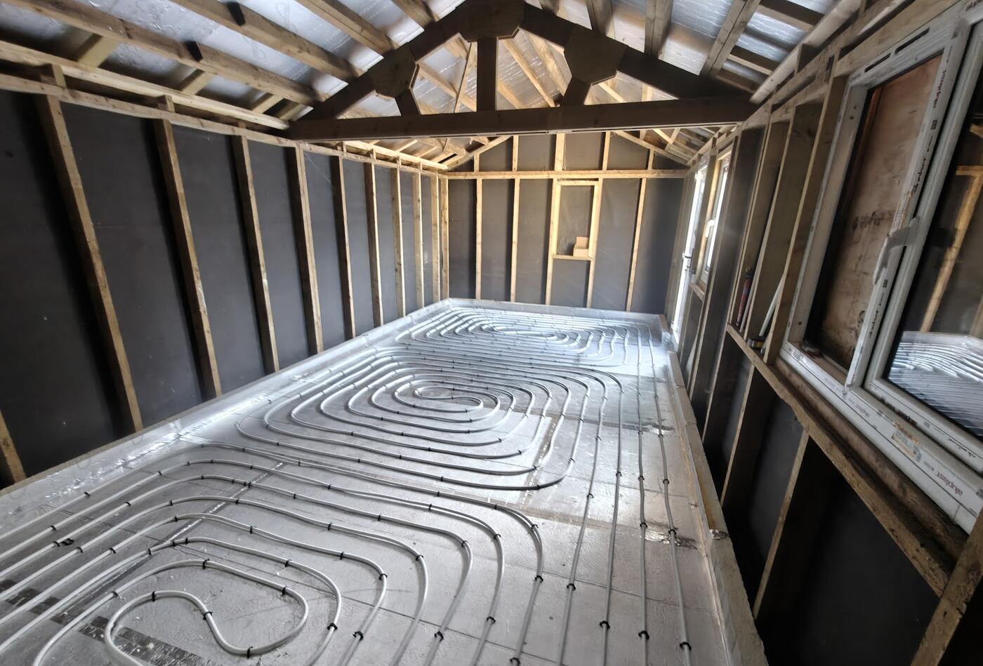 Underfloor heating pipework installed in a garden room extension, ready for screed